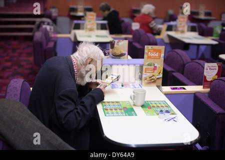 Mecca Bingo UK bingo company. People playing Bingo at Camden Town Bingo Hall, London, UK. Stock Photo