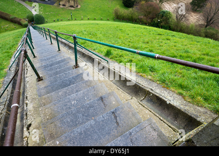 Lion's Mound Stairs Waterloo Belgium | WATERLOO, Belgium — Looking down the 226-step staircase of the Lion's Mound toward the surrounding parkland, this view captures the scale of the climb built into the Waterloo battlefield's principal monument. The steps, flanked by iron railings, descend from the summit platform beneath the cast-iron lion to the green fields below. Stock Photo