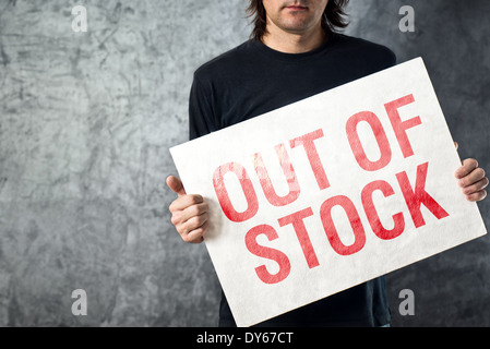 Out of Stock sign in hands of storage employee, shortage in supply chain Stock Photo