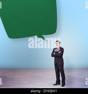 Composite image of young businessman standing cross-armed Stock Photo