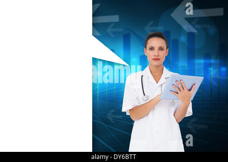 Composite image of pretty nurse using tablet pc with speech bubble Stock Photo