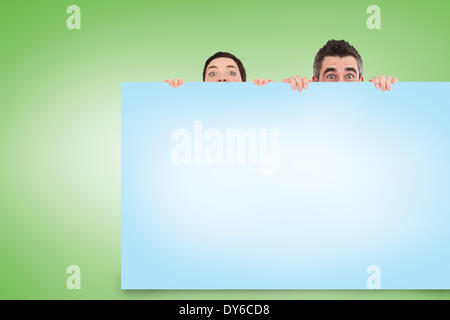 Composite image of couple showing card Stock Photo - Alamy