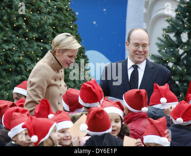 Prince Albert II of Monaco and Princess Charlene of Monaco hand out presents to Monaco children during the Christmas Celebration of St NicolasFeaturing: Prince Albert II of Monaco,Princess Charlene of Monaco Where: Monte Carlo MonacoWhen: 12 Dec 2012 Stock Photo