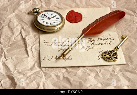 old letter with wax seal, vintage quill, clock and key Stock Photo