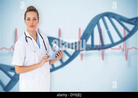 Composite image of pretty nurse using tablet pc Stock Photo