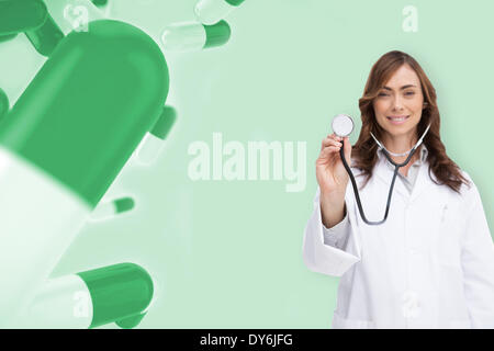 Composite image of happy doctor using stethoscope Stock Photo