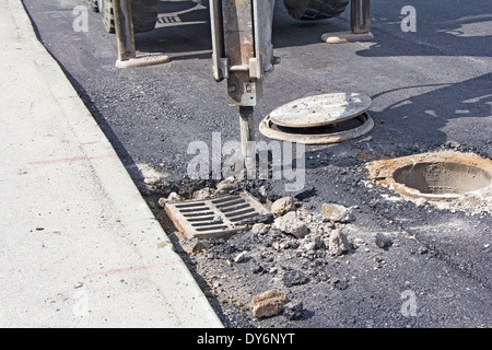 Breaking the asphalt pavement with jack hammer Stock Photo