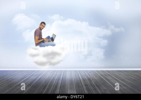 Composite image of man wearing glasses sitting on cloud  using laptop and looking at camera Stock Photo