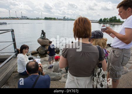 Tourists looking at the Copenhagen tourist attraction The Little Mermaid, 'Den lille havfrue'. Stock Photo