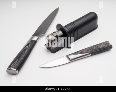 Kitchen knifes and knife sharpener cut out isolated on white background Stock Photo