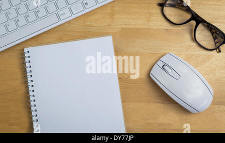Overhead of notebook and glasses Stock Photo