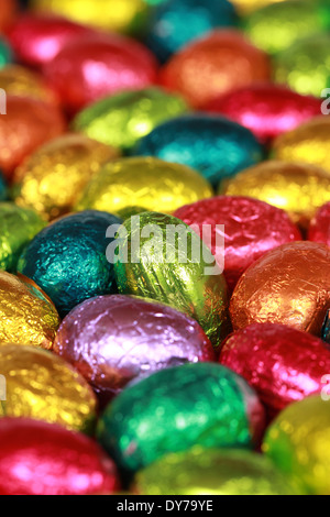 Colorful Easter eggs made of chocolate forming a background Stock Photo