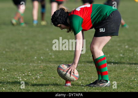 Aberystwyth university women (in red and green) playing rugby against Trinity St Davids university, Wales UK Stock Photo