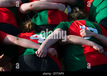 Aberystwyth university women (in red and green) playing rugby against Trinity St Davids university, Wales UK Stock Photo