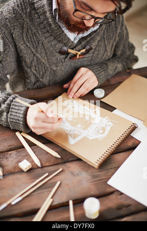 Image of young man in sweater drawing Stock Photo