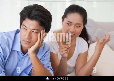 Couple sitting on the couch having a fight Stock Photo