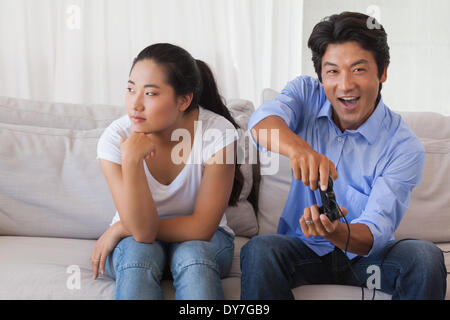 Premium Photo  Boyfriend sits engrossed in playing online games on his  smartphone, ignoring his girlfriend waiting.