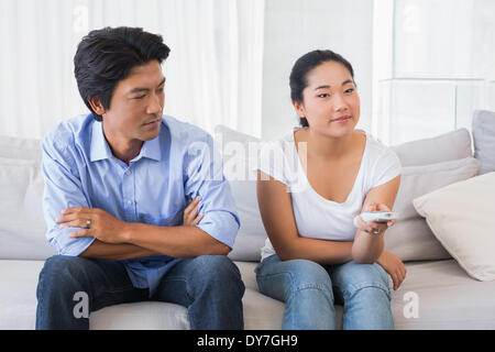 Man looking at girlfriend changing channel Stock Photo