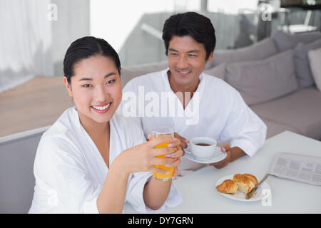 Couple in bathrobes spending the morning together Stock Photo