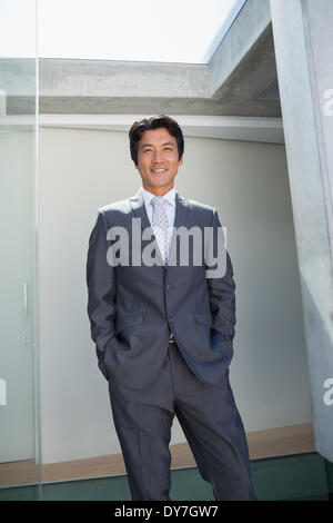 Confident estate agent standing at front door Stock Photo