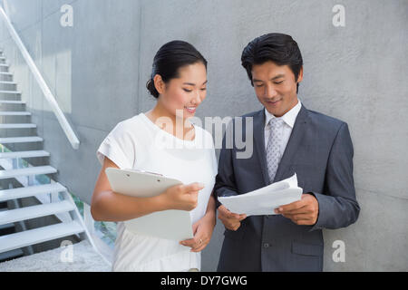 Estate agent showing lease to customer and smiling Stock Photo