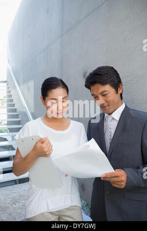 Estate agent showing lease to customer and smiling Stock Photo