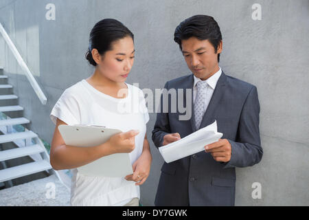 Estate agent showing lease to customer and smiling Stock Photo