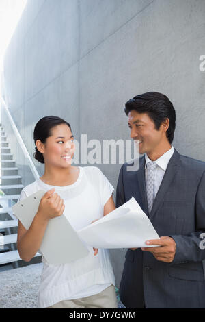 Estate agent showing lease to customer and smiling Stock Photo