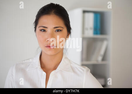 Casual businesswoman frowning at camera Stock Photo