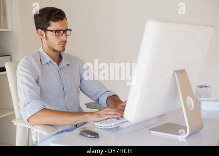 Casual businessman working at his desk Stock Photo