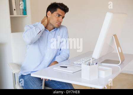 Casual businessman touching his sore neck Stock Photo