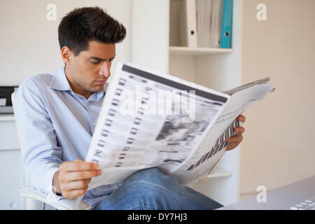 Casual businessman reading the newspaper Stock Photo