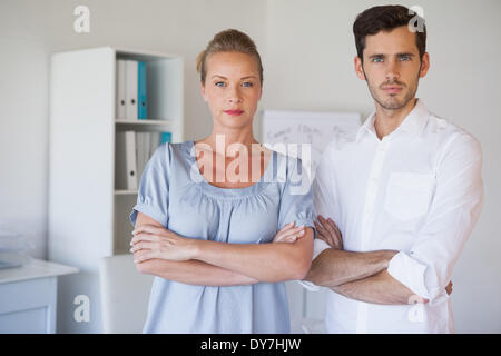 Casual business team looking at camera with arms crossed Stock Photo ...