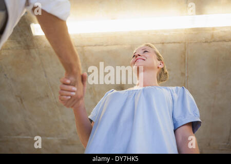 Casual business woman shaking hands with someone Stock Photo