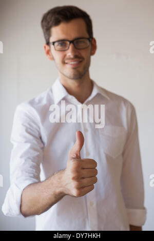 Casual businessman giving thumbs up to camera Stock Photo