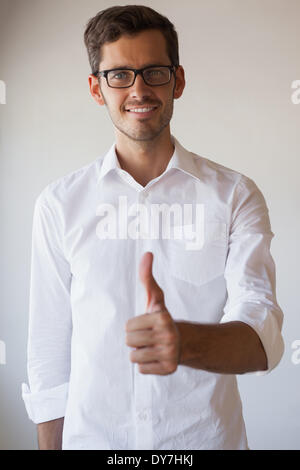 Casual businessman giving thumbs up to camera Stock Photo