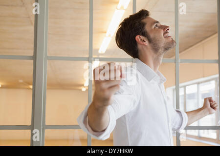 Casual businessman smiling and cheering Stock Photo