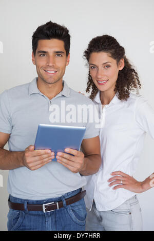 Casual business team looking at tablet together Stock Photo