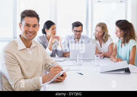 Casual businessman taking notes during meeting Stock Photo