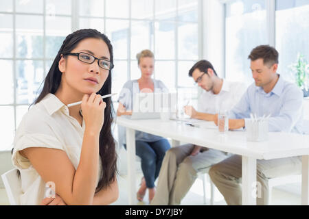 Casual businesswoman thinking during a meeting Stock Photo