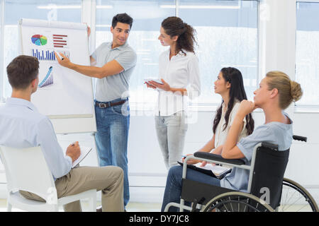 Casual businessman giving presentation to colleagues Stock Photo