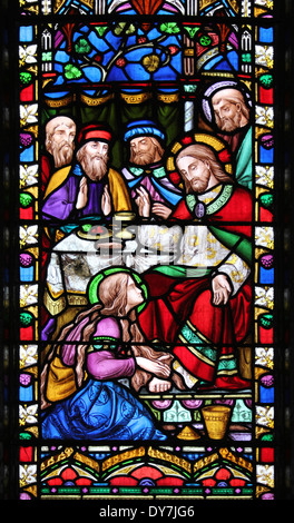 Stained Glass Window Panel Showing Mary, sister of Lazarus Greasing The Feet Of Jesus and Wiped His Feet Dry With Her Hair Stock Photo