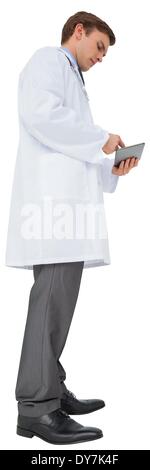 Young doctor in lab coat using tablet pc Stock Photo