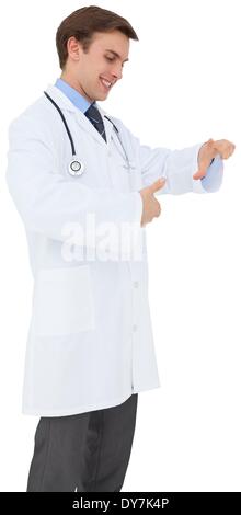 Young doctor in lab coat gesturing Stock Photo