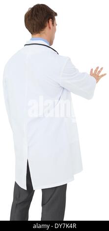 Young doctor in lab coat gesturing Stock Photo
