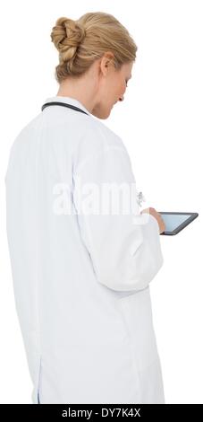 Blonde doctor in lab coat using tablet pc Stock Photo