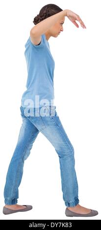 Powerless brunette in jeans and tshirt Stock Photo