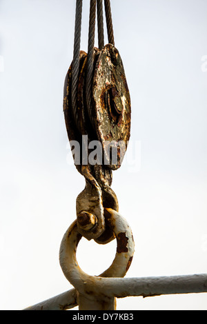 Old rusted crane pulley close up Stock Photo