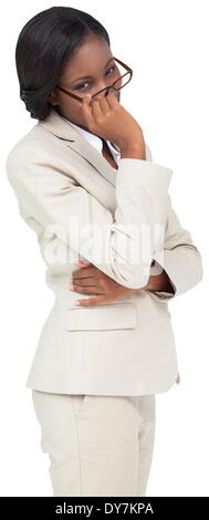 Thinking businesswoman in cream suit Stock Photo