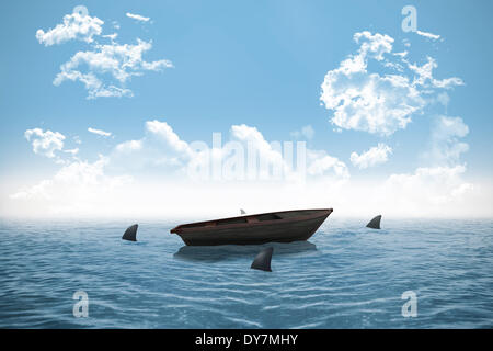 Sharks circling small boat in the ocean Stock Photo